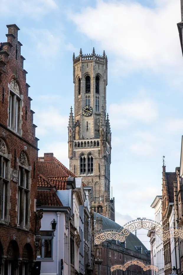 Torre del campanario de Brujas sobre las calles adoquinadas
