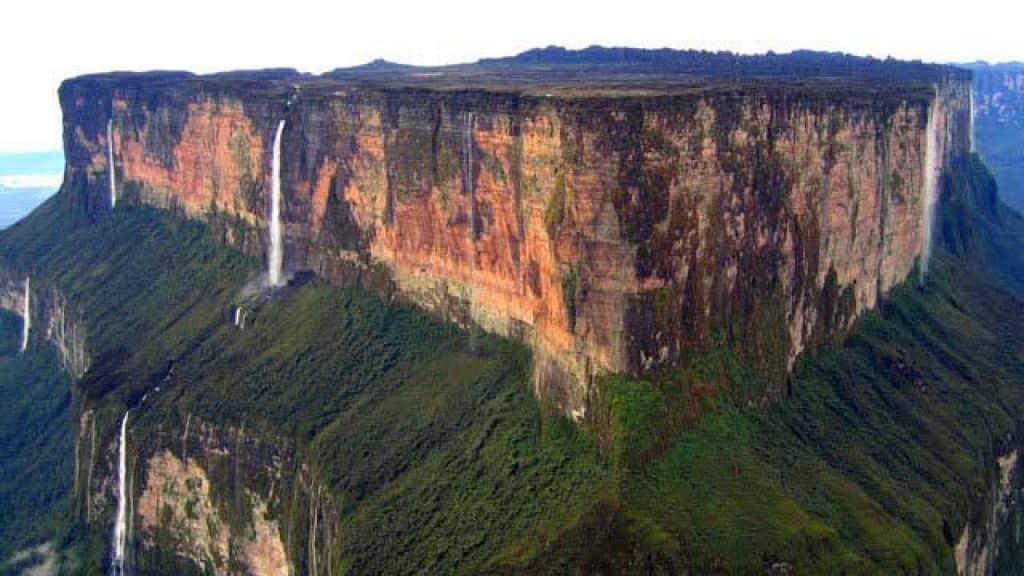 Dark-water waterfall among vegetation in La Gran Sabana
