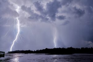 Two lightning bolts over Lake Maracaibo at night, seen from a boat