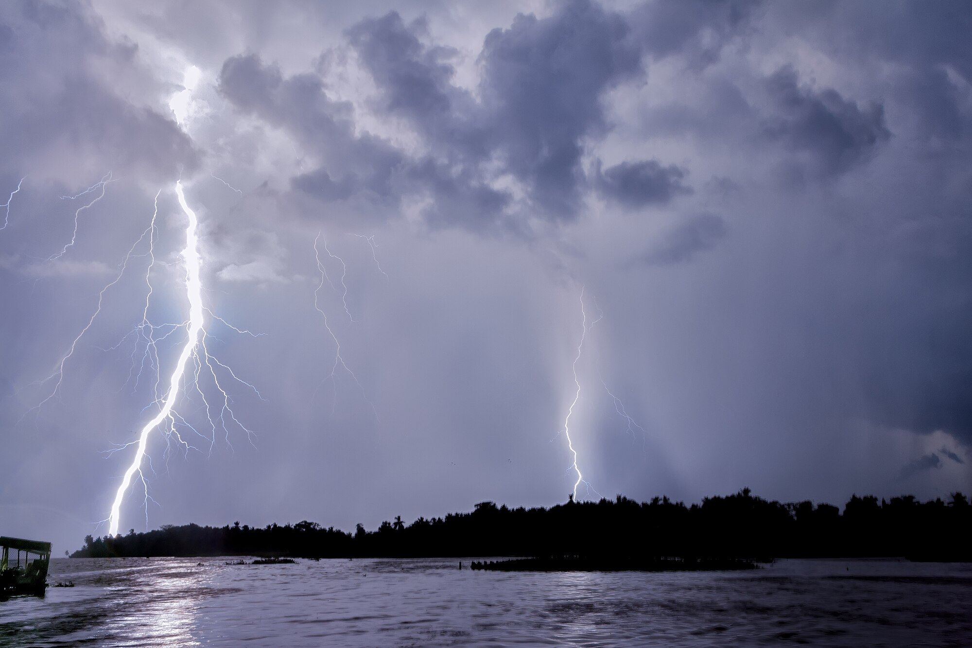Two lightning bolts over Lake Maracaibo at night, seen from a boat